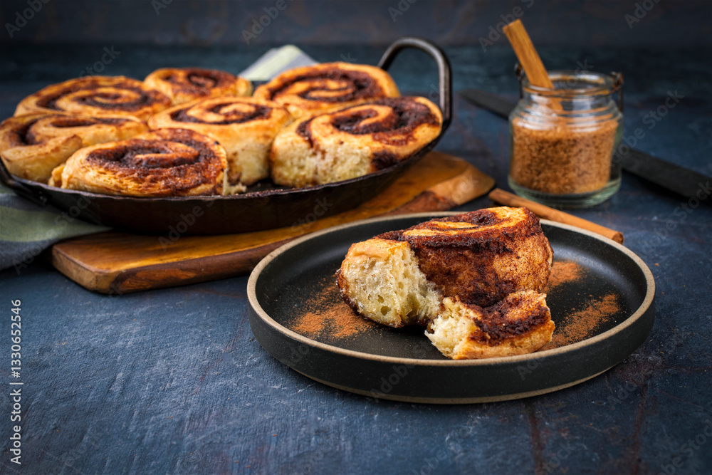 Homemade cinnamon snail rolls backed with brown sugar served as close-up in skillet pan Homemade cinnamon snail rolls backed with brown sugar served as close-up in skillet pan