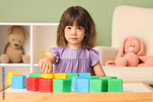 Cute little girl playing wi...