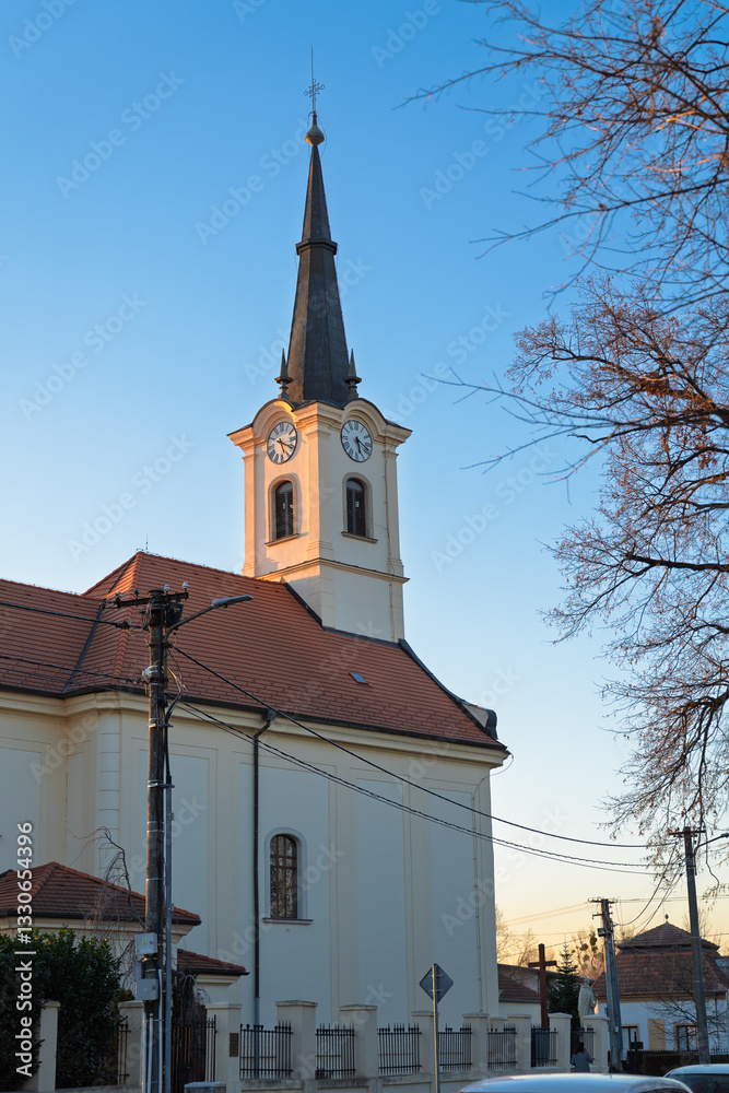 Obraz premium Church of Saint John the Baptist in Ivanka pri Dunaji, Slovakia at sunset