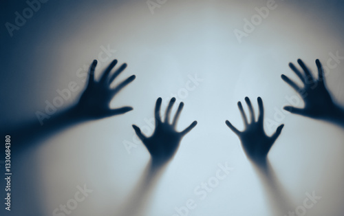 Shadows of Outstretched Hands on a Blue Background Creating Mysterious Mood