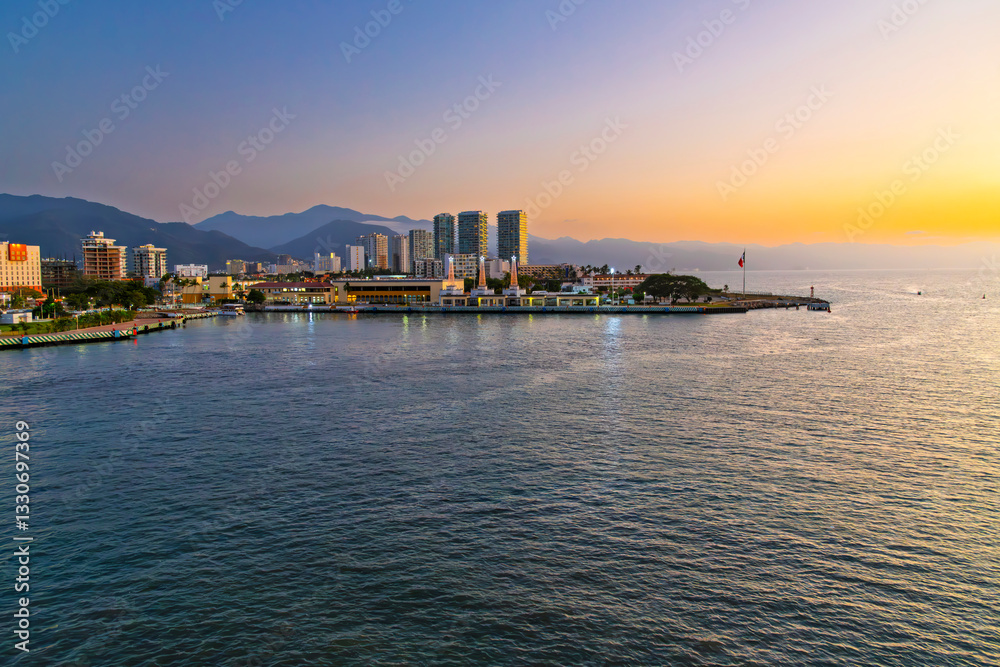 Evening sunset view of the Puerto Vallarta coastline and skyline at Golden Hour from the cruise port at Puerto Vallarta, Mexico. Evening sunset view of the Puerto Vallarta coastline and skyline at Golden Hour from the cruise port at Puerto Vallarta, Mexico.