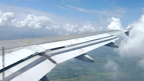Airplane wing flying through clouds
