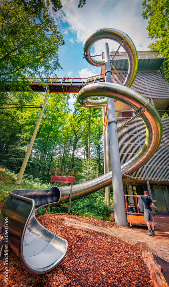 Amazing summer view of observation deck in Natural Heritage Centre Rugen. Stunning morning scene of metal tube among foliage woodland. Beauty of nature concept background.