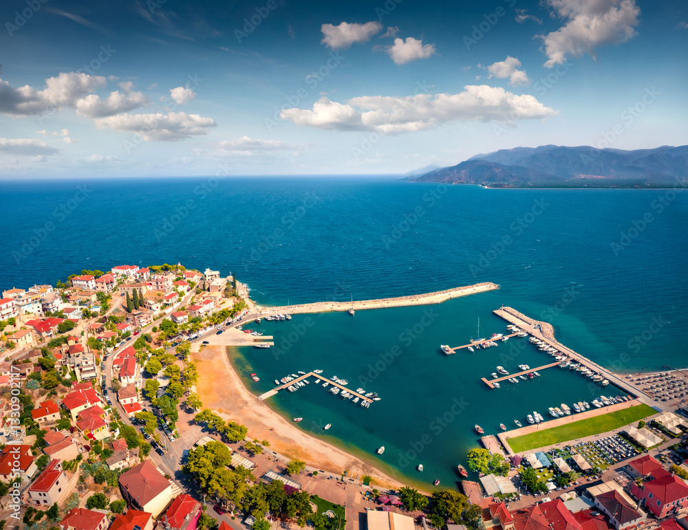 Bright summer cityscape of Paralio Astros port. Amazing morning seascape of Myrtoan Sea. Colorful urban scene of Arcadia region, Greece, Europe. Traveling concept background.