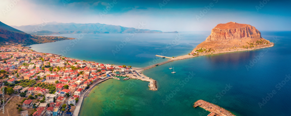 Panoramic morning view from flying drone of Monemvasia island. Stunning summer scene of Peloponnese peninsula, Greece, Europe. Beautiful seascape of Myrtoan Sea.