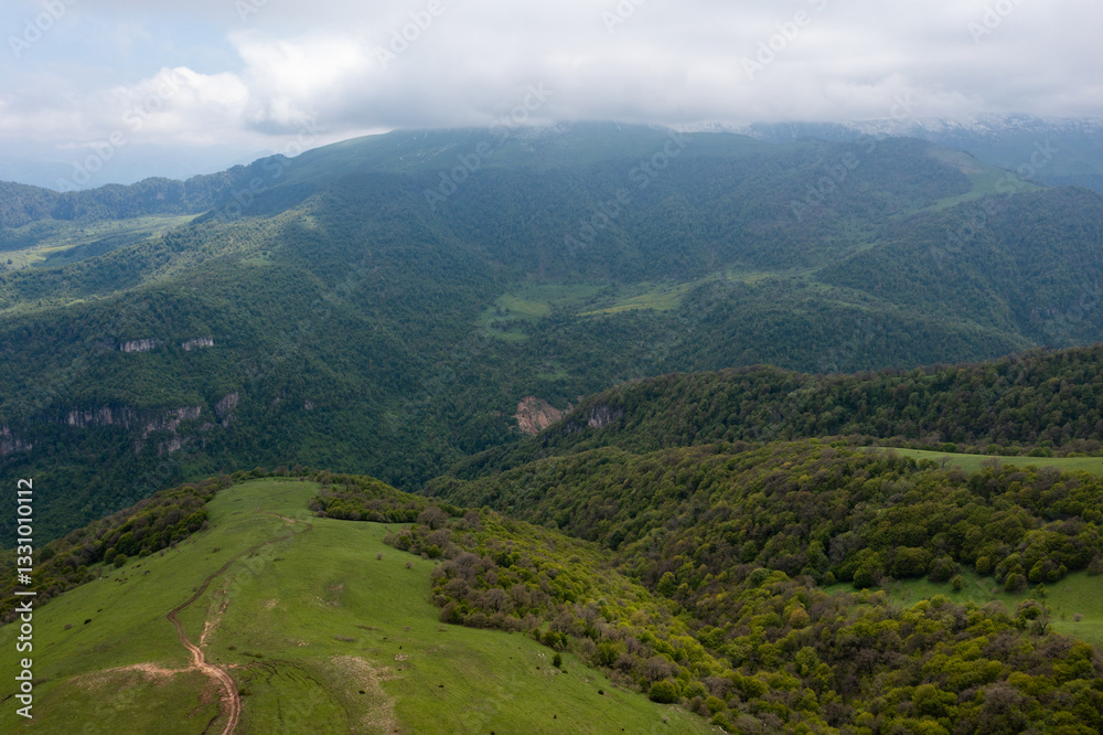 Obraz premium Aerial drone photos of Tavush mountains near Lastiver and Yenokavan, Armenia, in late spring and early summer. Green hills, remote trails, and misty peaks create a scenic travel destination