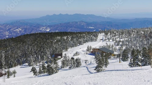 Snow covered forest and mountains with blue sky. Yokoteyama, Japan.  Handheld