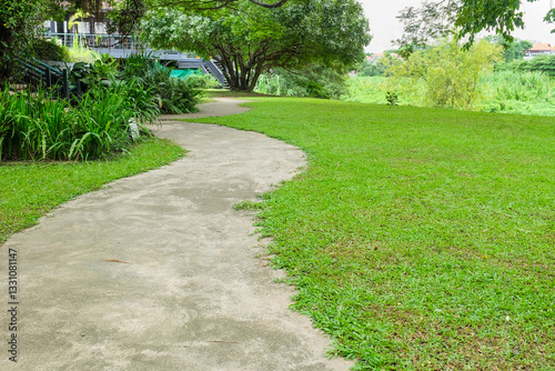 Fototapeta Naklejka Na Ścianę i Meble -  Garden landscape design with pathway in garden and footpath in picturesque summer park and staircase in backyard,Paving stones on floor in park,space for text.
