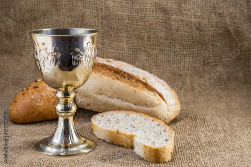 Bread and chalice of wine with copy space background. Maundy Thursday concept.