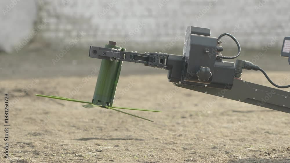 A demining robot moves an anti-personnel mine A demining robot moves an anti-personnel mine