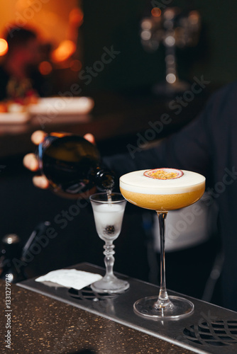Obraz na płótnie sweet and sour refreshing cocktail decorated with passion fruit on the bar counter w salonie