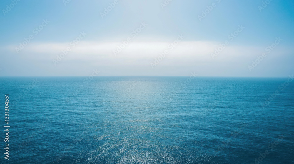Tranquil blue ocean under clear sky reflecting sunlight Tranquil blue ocean under clear sky reflecting sunlight