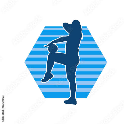 Silhouette of a slim sporty woman doing stretching exercise using gym ball. Silhouette of a sporty female doing physical workout using fitness ball. 