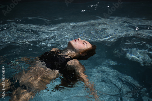 child doing the plank in a swimming pool