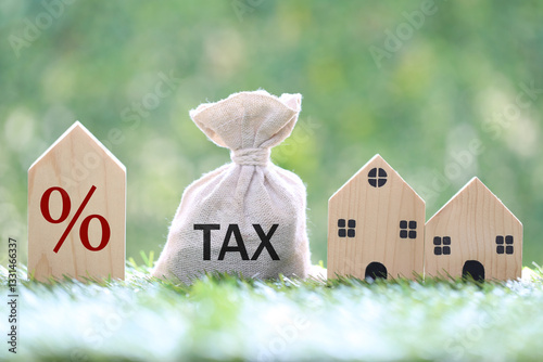 Estate tax, Model house and percentage symbol icon and stack of coins money on natural green background,Business investment and Property tax concept