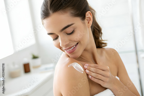 Smiling Woman Applying Moisturizer on Shoulder in Bright Bathroom, Promoting Self-Care and Skin Hydration Routine for Healthy Skin Glow