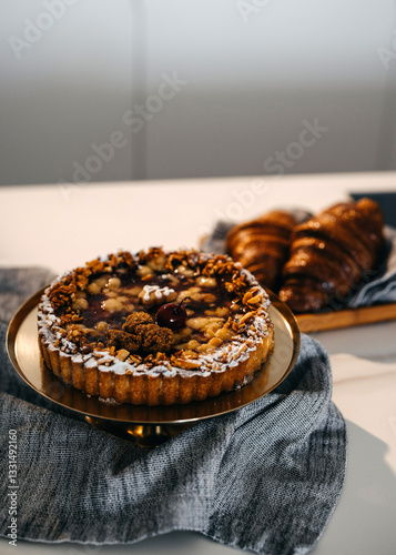 Fresh baked tart with nuts and cherries at home.