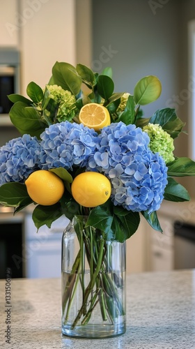 Beautiful Blue Hydrangeas and Yellow Lemons in a Glass Vase on a Kitchen Coun...