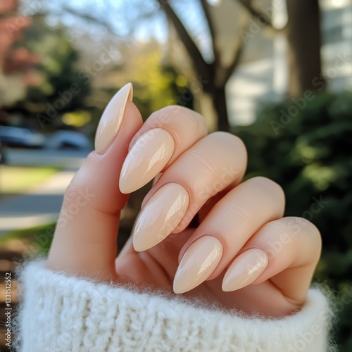 Elegant Long Almond Nail Design With Nude Polish Showcased in Natural Light O...