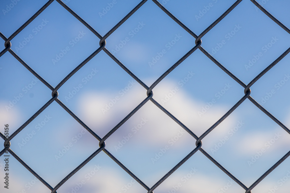 Wire fence against the sky with beautiful cloud formation Wire fence against the sky with beautiful cloud formation