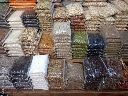 Variety of Packed Spices, Grains, and Pulses in a Market Display
