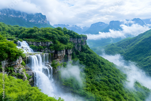 Majestic waterfall cascading down a cliff face, surrounded by lush green forests and misty mountains