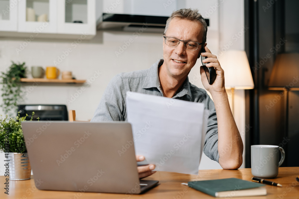 Mature businessman working online from home, small business lifestyle. Mature businessman working online from home, small business lifestyle.