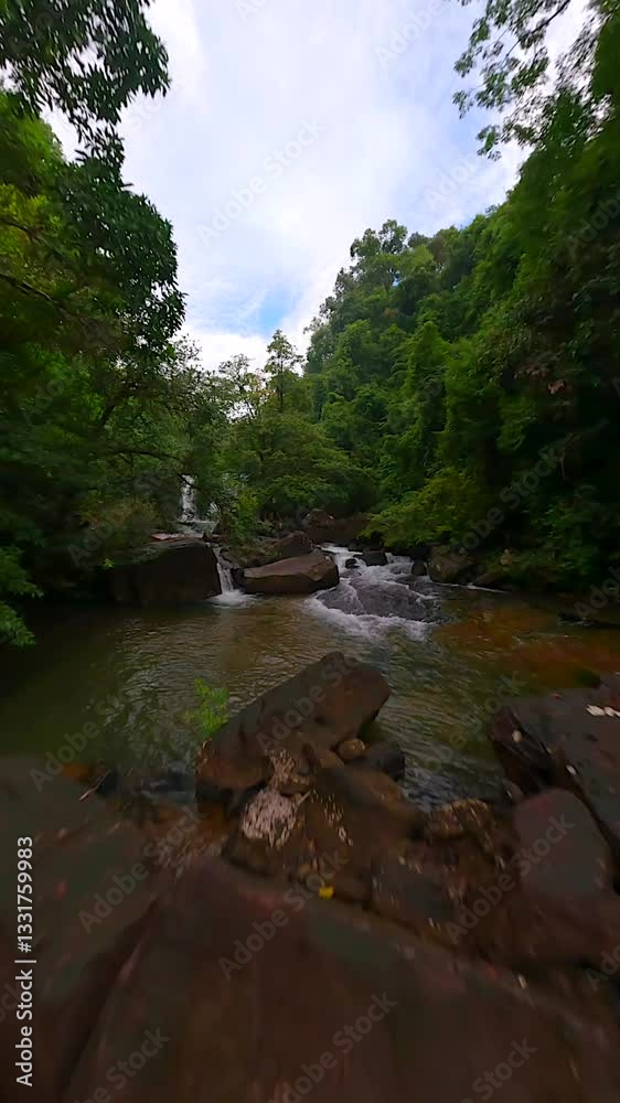 Cinematic FPV drone flight over tropical river and waterfalls in lush jungle, Thailand Cinematic FPV drone flight over tropical river and waterfalls in lush jungle, Thailand