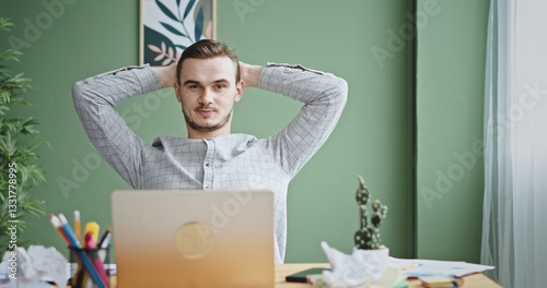 A Relaxed Young Professional Enjoying a Modern Workspace with a Focus on Calmness and Productivity