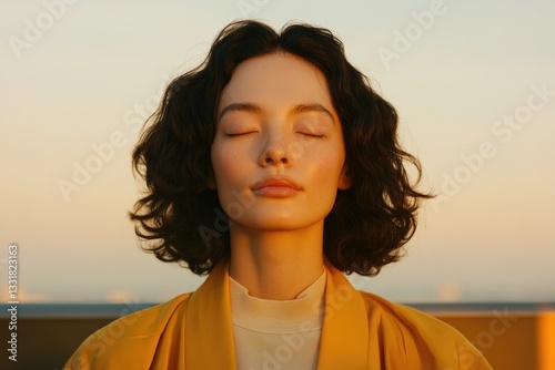 Serene woman with closed eyes enjoys sunset, radiating calm and