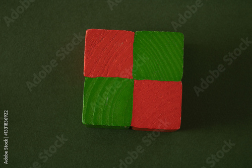Green and red wooden cubes on a school desk