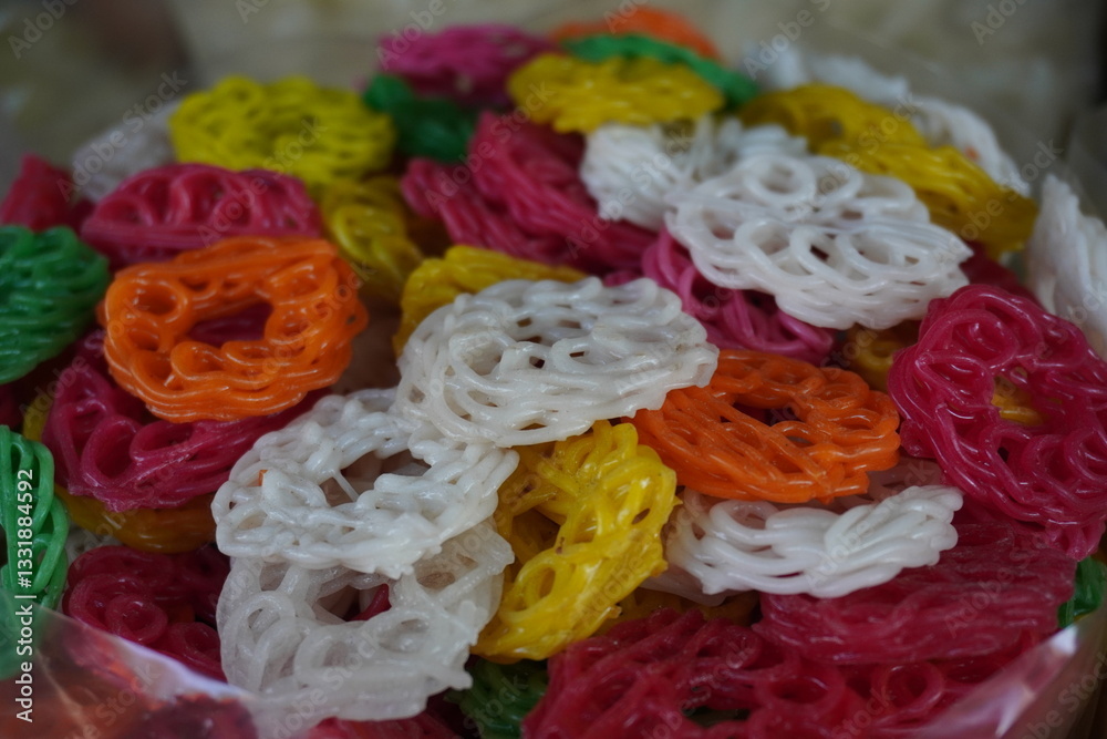 Sabudana Jalebi, a colorful, ready-to-fry snack made from sago which is also known as Sago Fryums or Sabudana Papad a well-known snacks from West Bengal, India Sabudana Jalebi, a colorful, ready-to-fry snack made from sago which is also known as Sago Fryums or Sabudana Papad a well-known snacks from West Bengal, India