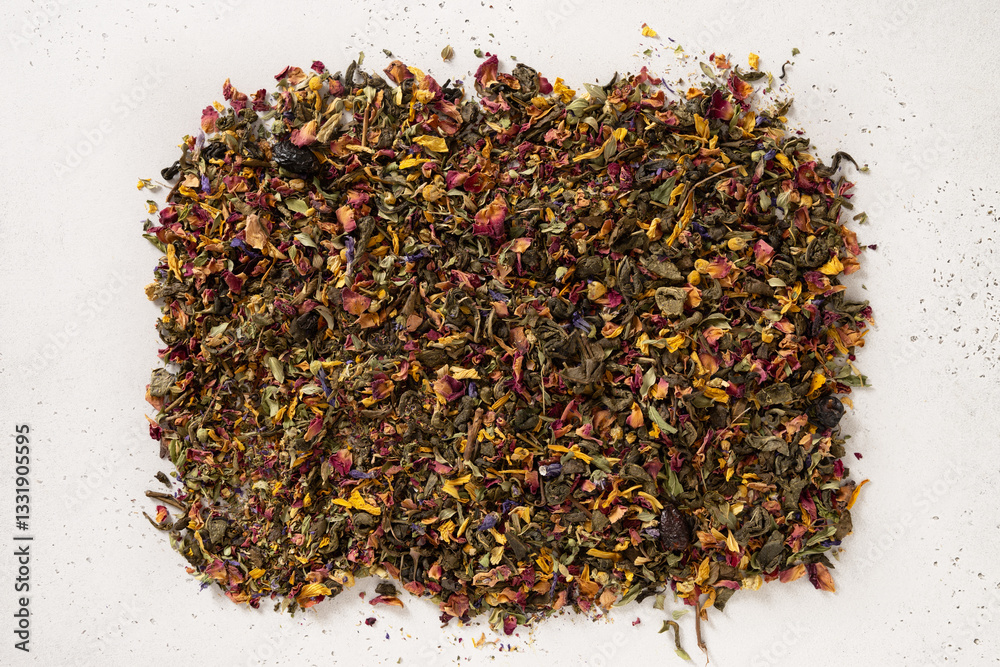 Pile of dry herbal tea and flowers green tea on white background. View from above. Dry tea leaves texture.