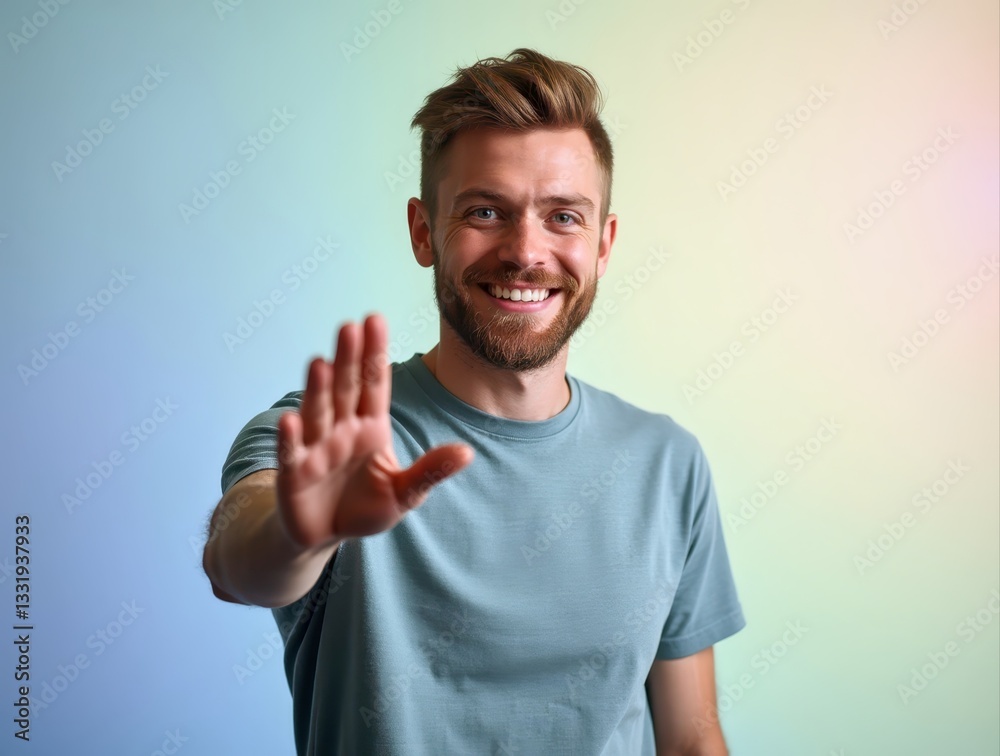 Smiling man making stop gesture on gradient background Smiling man making stop gesture on gradient background