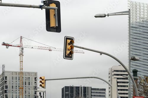 Traffic lights and urban infrastructure with modern buildings in the background, capturing city dynamics. photo