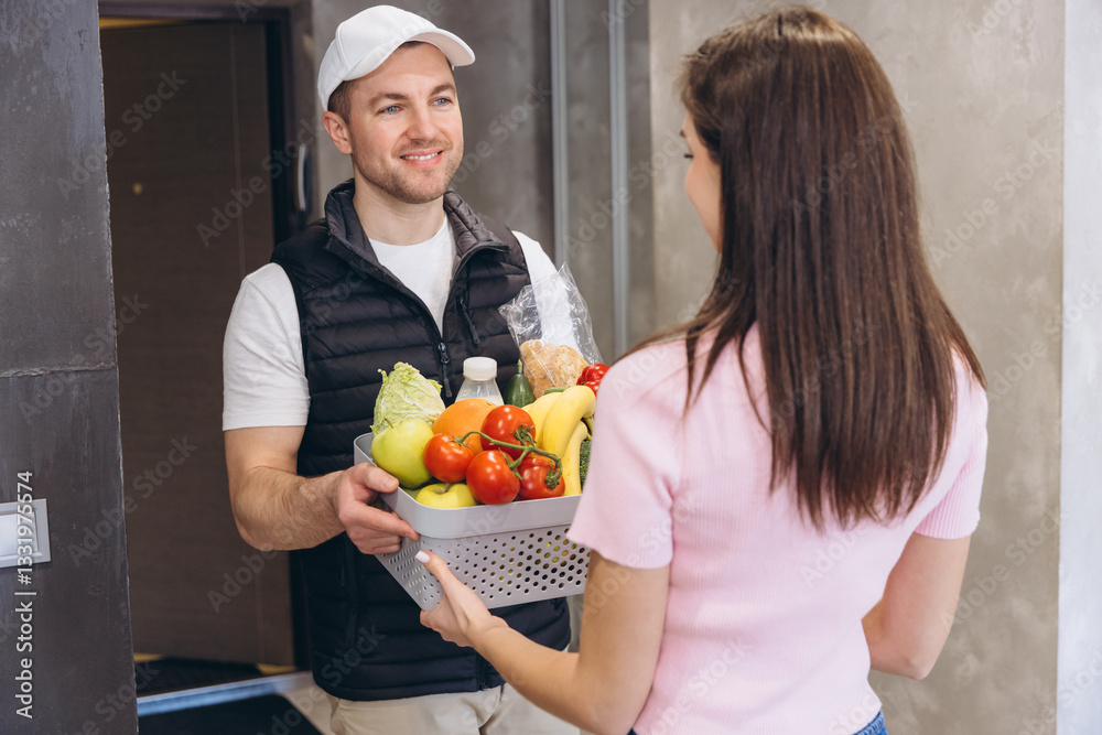 Delivery man giving grocery basket to woman at home Delivery man giving grocery basket to woman at home