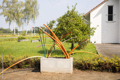 Offene Glasfaser-Verteilerbox mit bunten Glasfaser-Rohren – Breitbandausbau in Wohngebieten, modernes Telekommunikationsnetz für Highspeed-Internet und Digitalisierung.