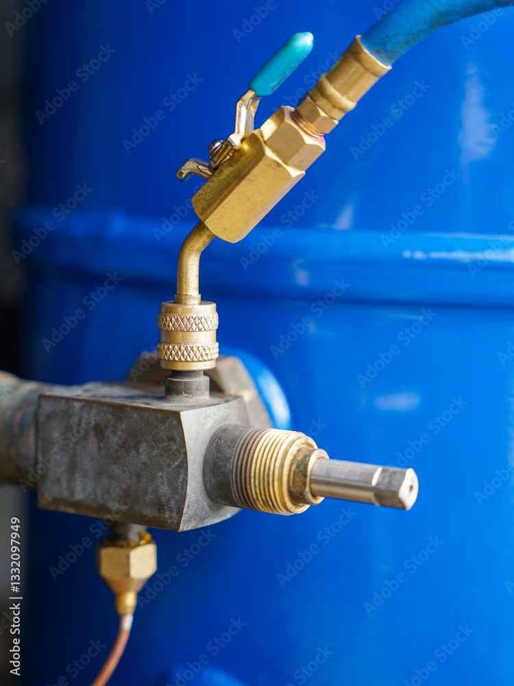 Detail of industrial refrigeration compressor with valve and connected service hose, refrigeration maintenance concept