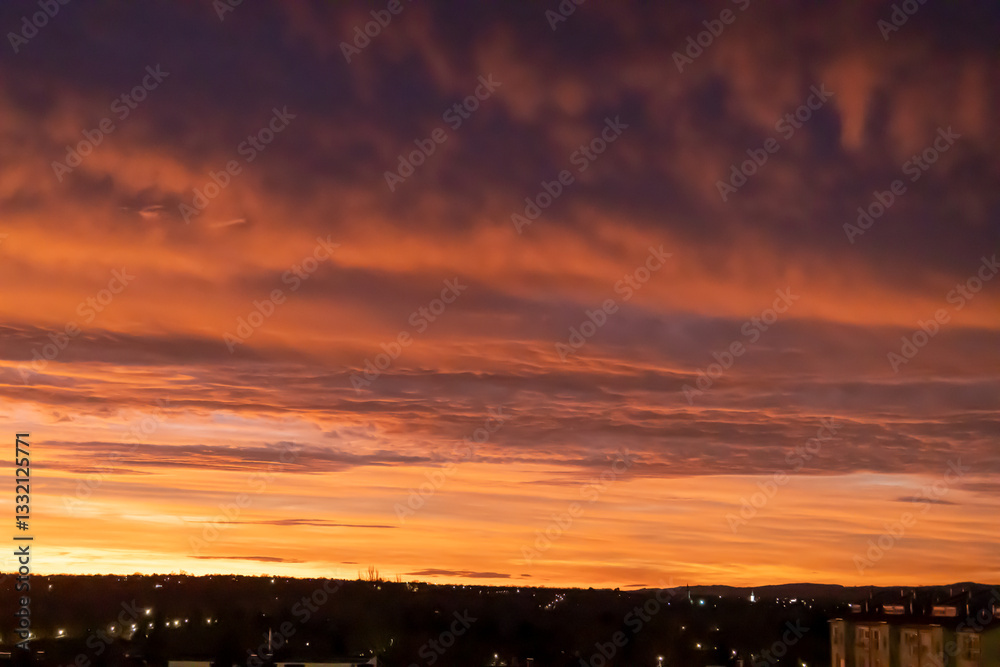 Sunrise sky with pink and orange clouds, silhouetted city skyline. Sunrise sky with pink and orange clouds, silhouetted city skyline.