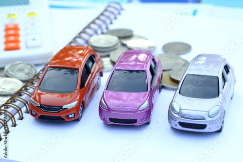 Toy car and money on white background. Vehicle insurance concept.