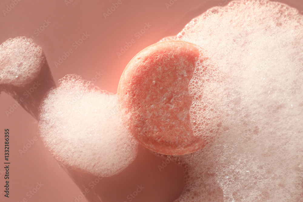 Soap bar with foam on dusty rose background, top view Soap bar with foam on dusty rose background, top view