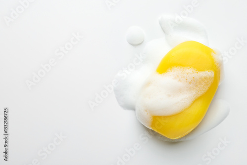 Soap bar with foam on white background, top view. Space for text