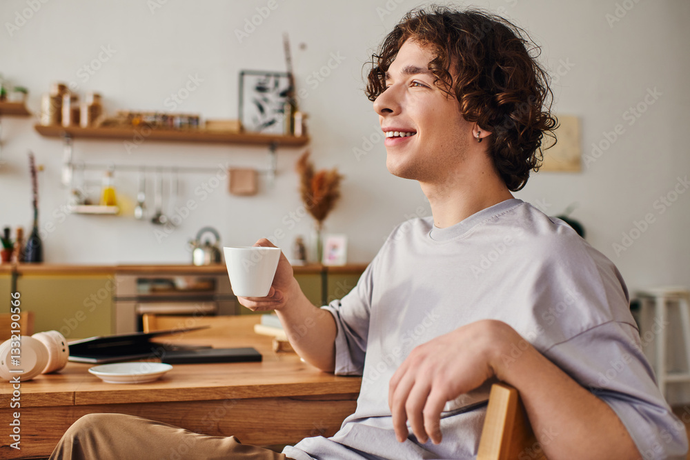 Young handsome man enjoying a coffee break in a modern office setting with a cheerful smile Young handsome man enjoying a coffee break in a modern office setting with a cheerful smile