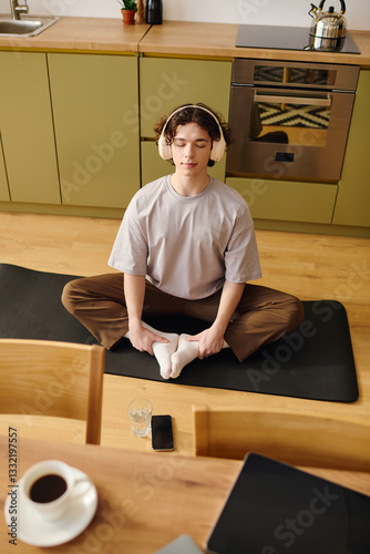 Photography Handsome young man practicing mindfulness meditation in a modern office kitchen