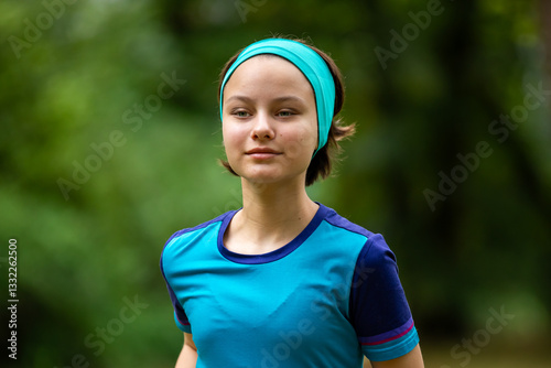 Obraz na płótnie Beautiful teen girl in sports clothes doing sports outdoors in park in summer w salonie