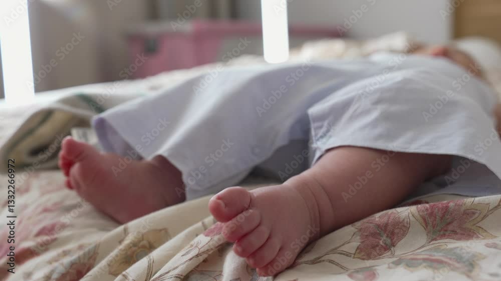 Close-up of a baby’s feet resting on a patterned bedspread, with the baby wearing light-colored clothing. Soft and serene moment captured in a cozy indoor environment Close-up of a baby’s feet resting on a patterned bedspread, with the baby wearing light-colored clothing. Soft and serene moment captured in a cozy indoor environment