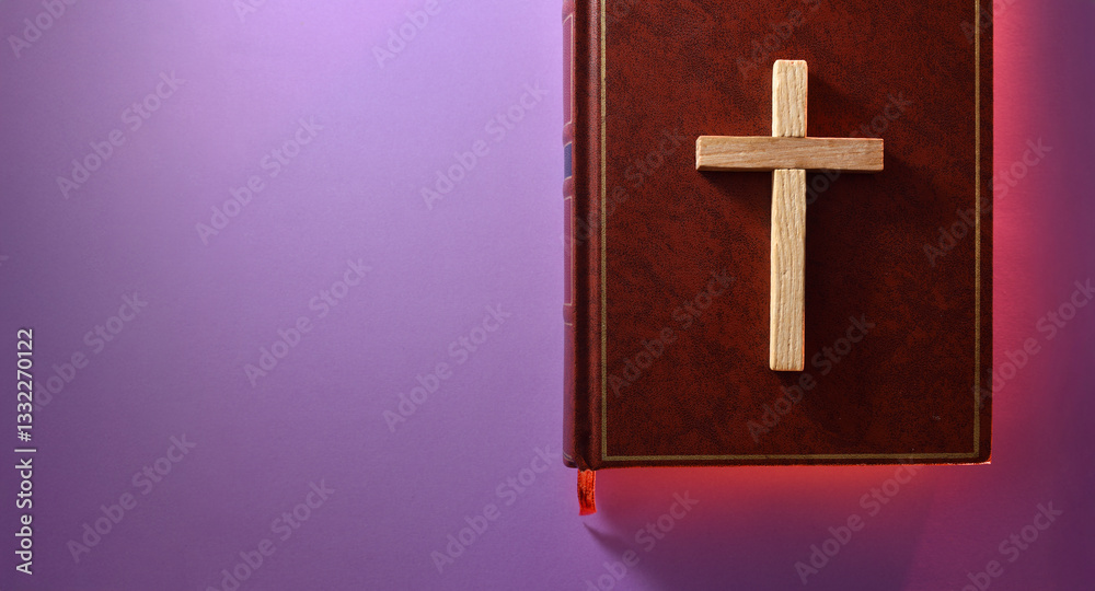 Obraz premium Bible cover with cross and red sparkle around on purple