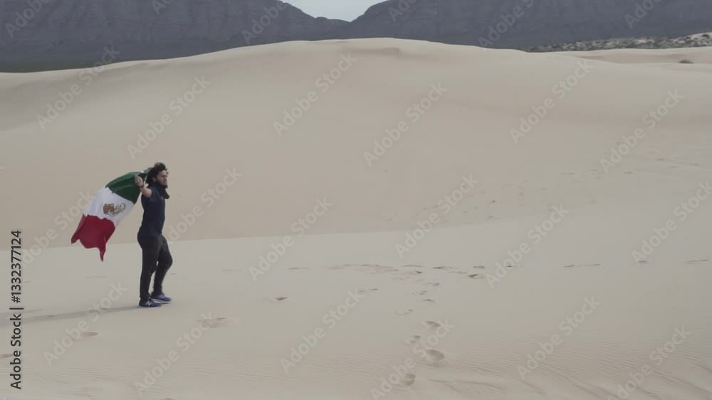 Slow-motion of Brazilian man with afro hairstyle walking with Mexican flag in the desert in Mexico