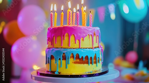 Vibrant birthday cake with tiered layers, candles, and dripping icing