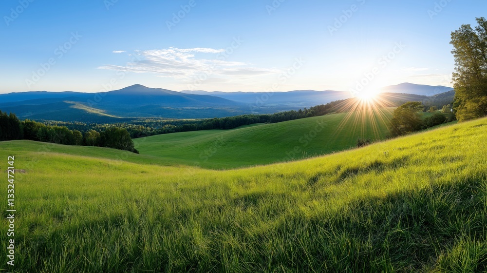 Obraz premium Scenic Sunrise Over Rolling Green Hills and Distant Mountains